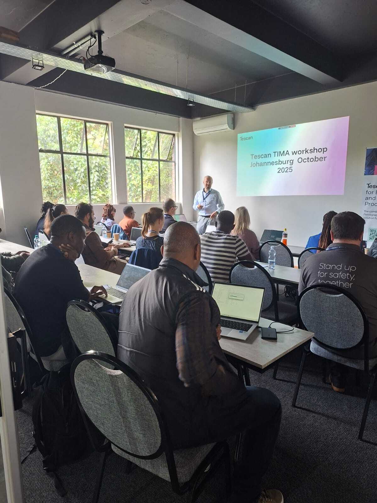 Tescan and Wirsam team banners displayed during the 2025 TIMA User Workshop
